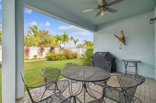 view of patio with a grill and ceiling fan