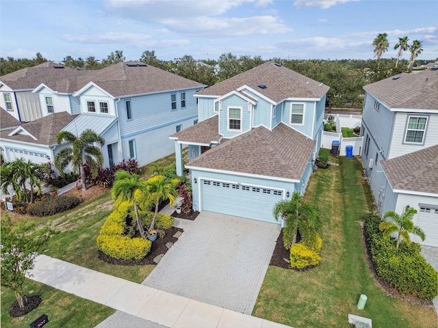 307 Shore Crab Way, Apollo Beach, FL 33572 - view of front facade featuring a garage, driveway, a shingled roof, and a residential view