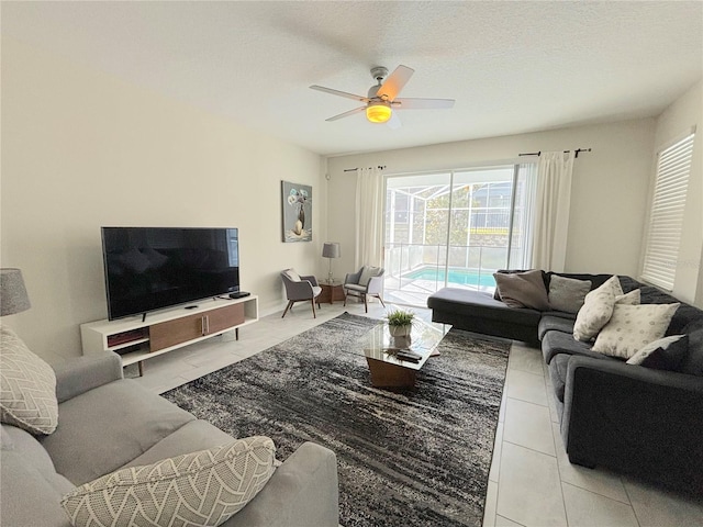 tiled living room featuring a textured ceiling and ceiling fan