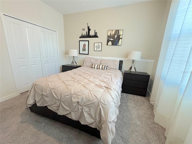 bedroom featuring multiple windows, light carpet, and a closet