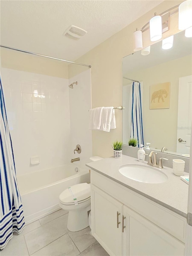 full bathroom with tile patterned floors, vanity, a textured ceiling, shower / tub combo, and toilet