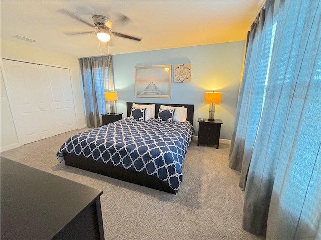 bedroom featuring carpet, ceiling fan, and a closet