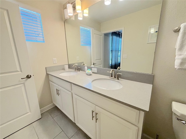 bathroom with tile patterned flooring, vanity, and toilet