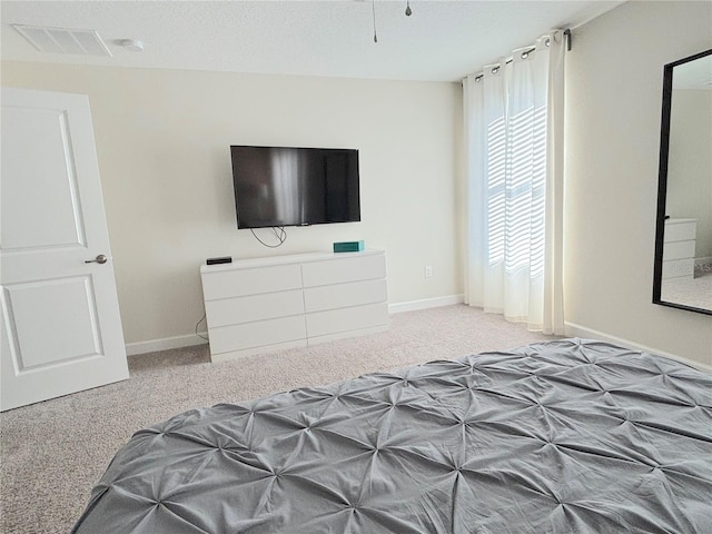 bedroom with a textured ceiling and carpet floors