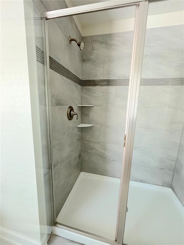 bathroom with a shower with shower door