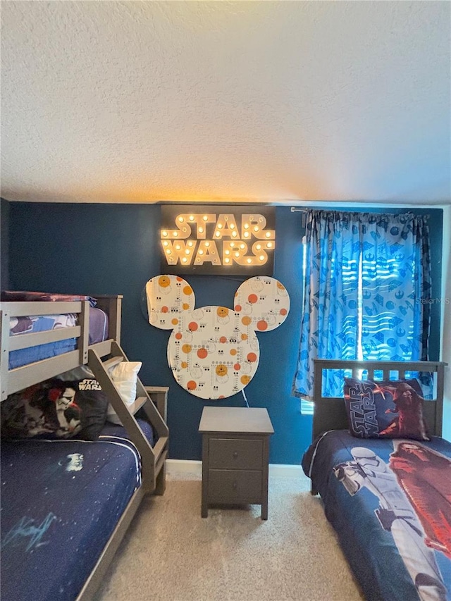 bedroom featuring carpet floors and a textured ceiling