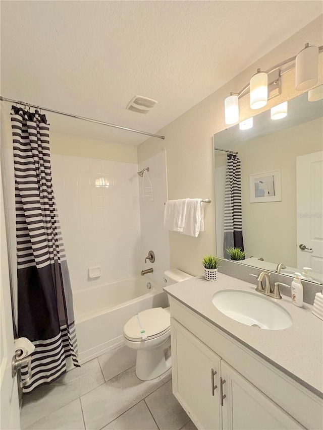 full bathroom with tile patterned floors, vanity, a textured ceiling, toilet, and shower / bath combo with shower curtain