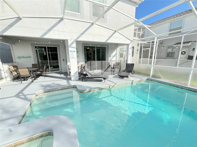 view of pool with a lanai and a patio