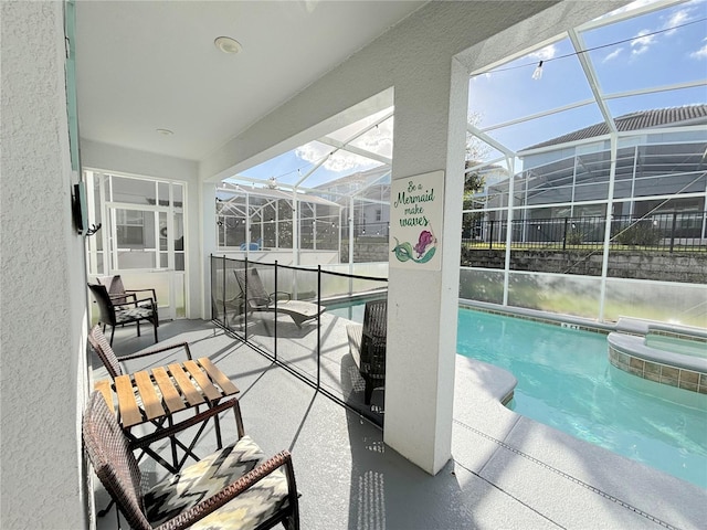 view of pool with a lanai, a patio, and an in ground hot tub