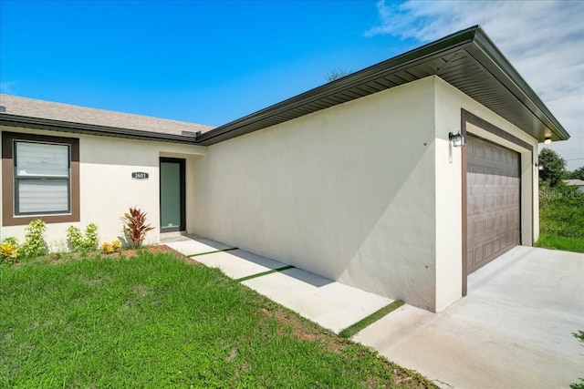 entrance to property with a garage and a yard