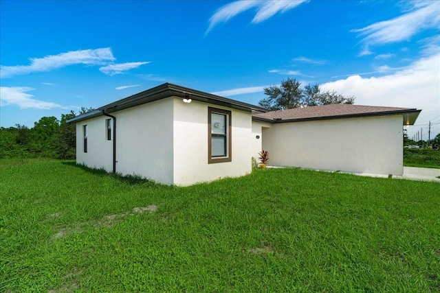 view of side of property with a lawn