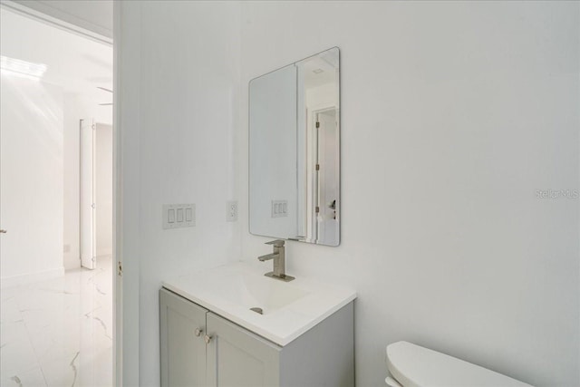 bathroom with toilet and vanity