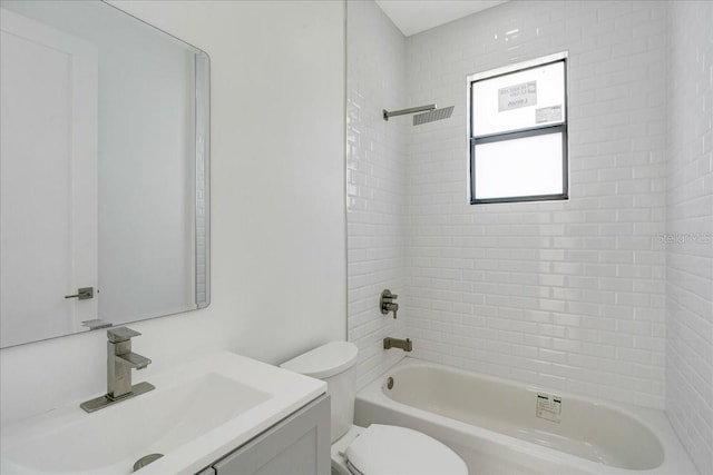 full bathroom with toilet, tiled shower / bath combo, and vanity