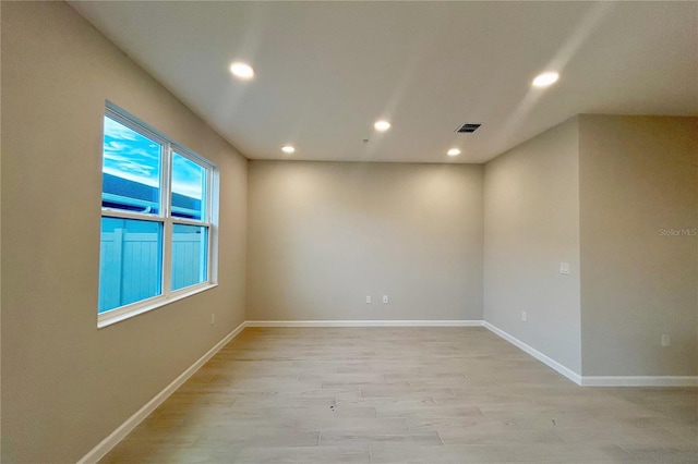 unfurnished room featuring light hardwood / wood-style floors