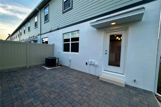 patio terrace at dusk featuring central air condition unit