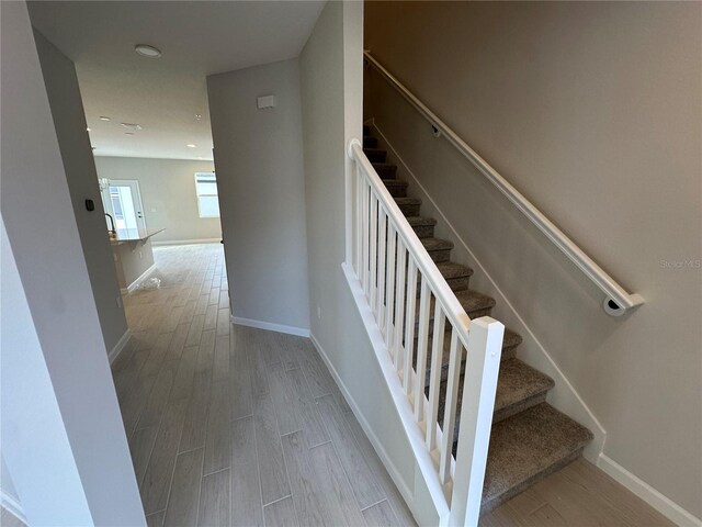 stairway featuring wood-type flooring