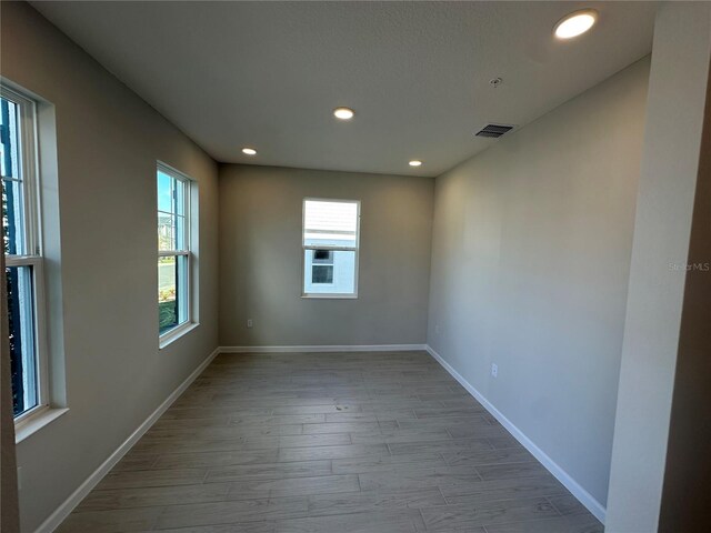 empty room with light hardwood / wood-style floors