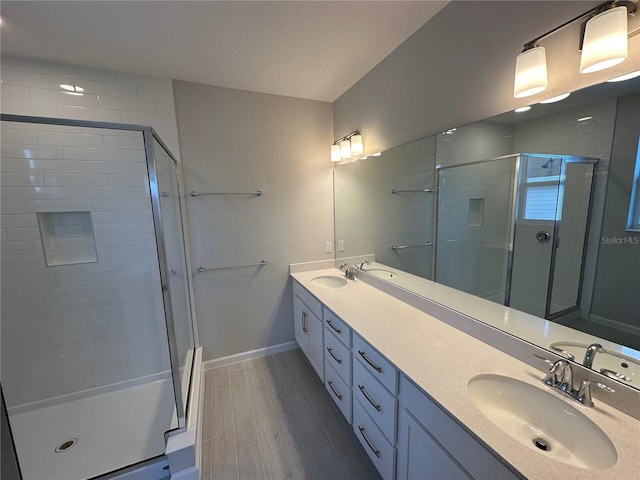 bathroom with vanity and a shower with shower door