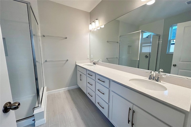 bathroom with vanity, an enclosed shower, and hardwood / wood-style flooring