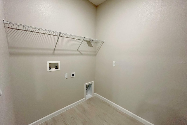 laundry room featuring washer hookup, light hardwood / wood-style floors, and electric dryer hookup