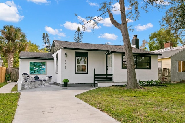 ranch-style house with a front lawn and a porch