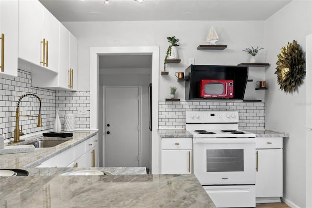 kitchen featuring light stone countertops, sink, backsplash, electric range, and white cabinetry