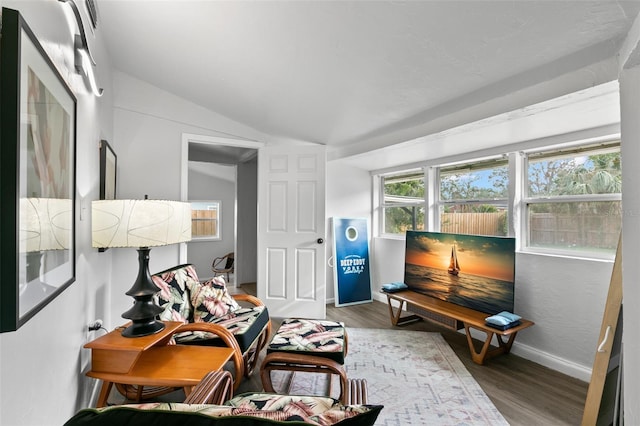 sitting room featuring lofted ceiling and hardwood / wood-style flooring