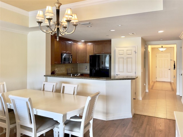 7612 Cabana Ct Unit 303, Reunion, FL 34747 - dining space with a chandelier, ornamental molding, recessed lighting, light wood finished floors, and baseboards