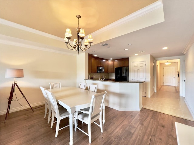 7612 Cabana Ct Unit 303, Reunion, FL 34747 - dining space featuring a chandelier, ornamental molding, baseboards, light wood finished floors, and recessed lighting