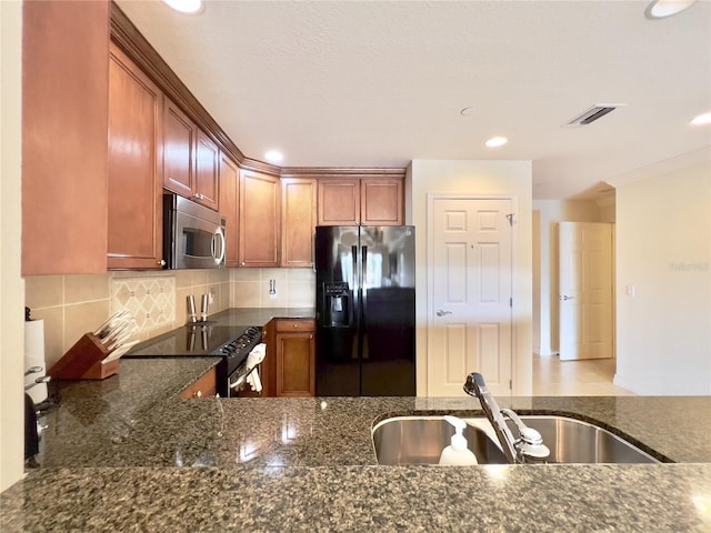 7612 Cabana Ct Unit 303, Reunion, FL 34747 - kitchen with black fridge with ice dispenser, stainless steel microwave, electric stove, a sink, and dark stone counters
