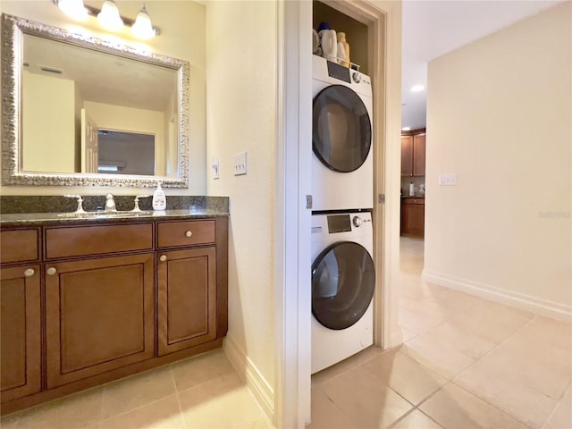 7612 Cabana Ct Unit 303, Reunion, FL 34747 - laundry area featuring stacked washer / drying machine, baseboards, and light tile patterned floors