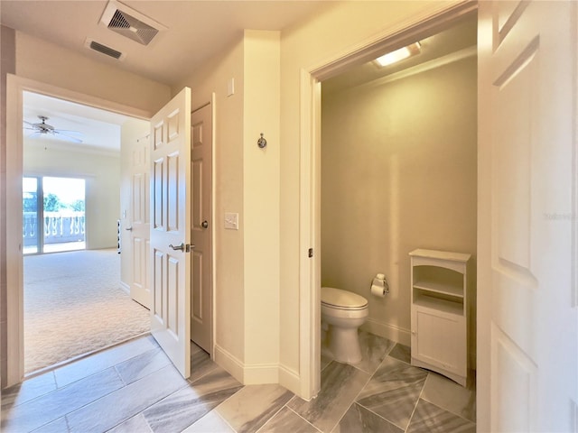 7612 Cabana Ct Unit 303, Reunion, FL 34747 - bathroom featuring toilet, baseboards, and ceiling fan