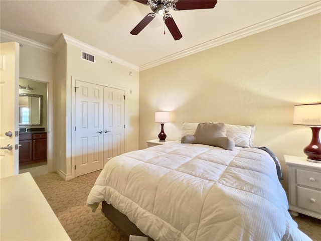 7612 Cabana Ct Unit 303, Reunion, FL 34747 - bedroom with light carpet, crown molding, a closet, connected bathroom, and ceiling fan