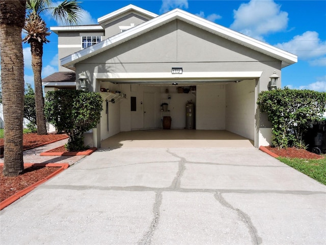 view of front of house featuring a garage and water heater