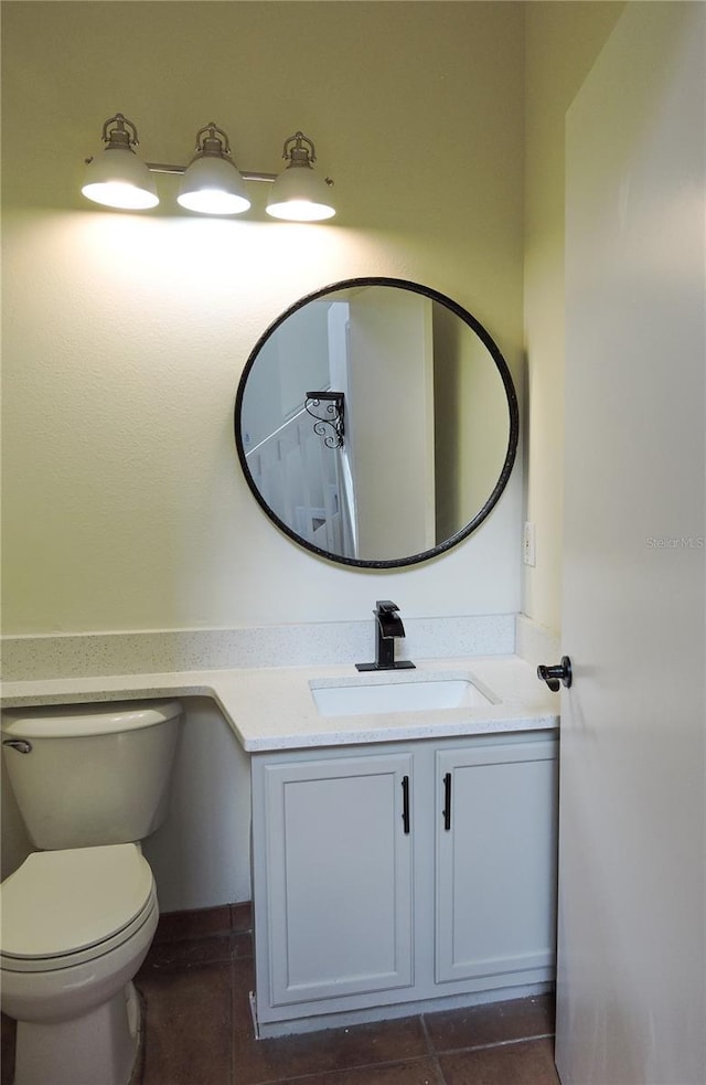 bathroom featuring vanity, toilet, and tile patterned flooring