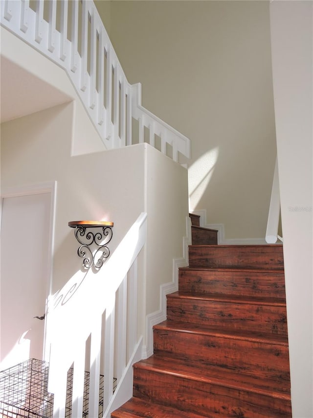 staircase with a high ceiling