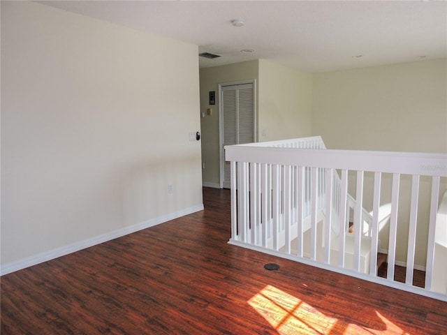 spare room featuring dark wood-type flooring