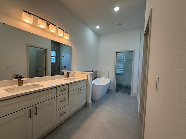 bathroom with vanity and separate shower and tub