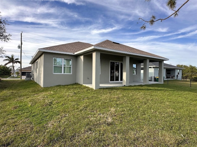 rear view of house featuring a lawn and a patio area