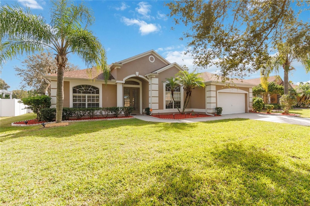 view of front of home with a garage and a front yard