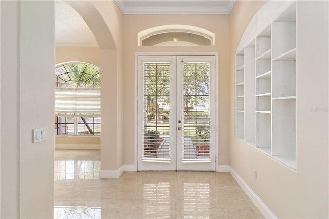 entryway featuring ornamental molding and french doors