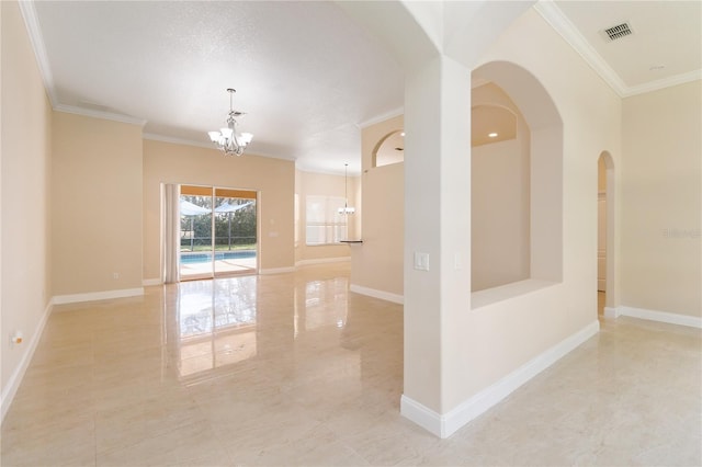 empty room featuring a textured ceiling, a notable chandelier, and ornamental molding