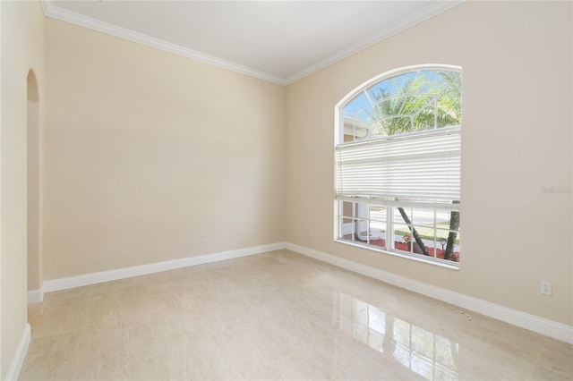 empty room featuring crown molding