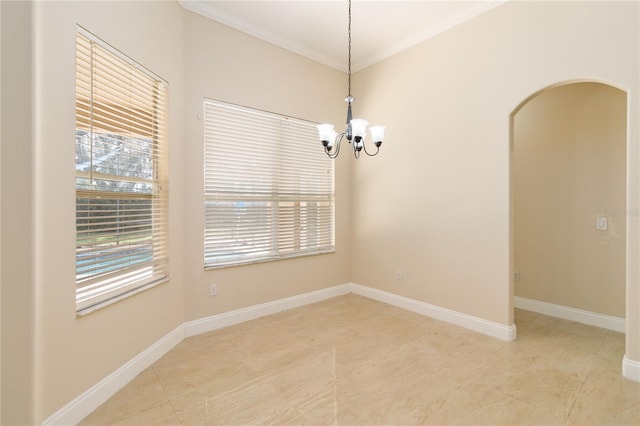 empty room featuring ornamental molding and a chandelier