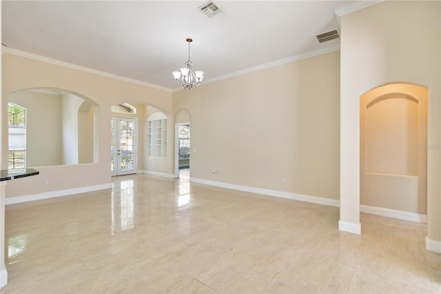 unfurnished room featuring french doors, crown molding, and an inviting chandelier