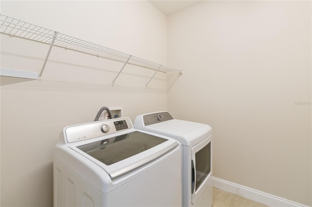 laundry area with washing machine and clothes dryer