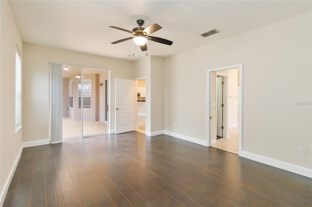 unfurnished room with dark hardwood / wood-style flooring and ceiling fan