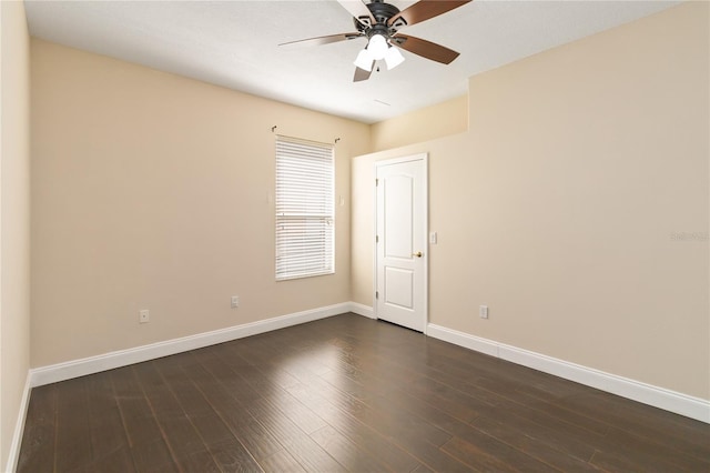 empty room with dark hardwood / wood-style floors and ceiling fan