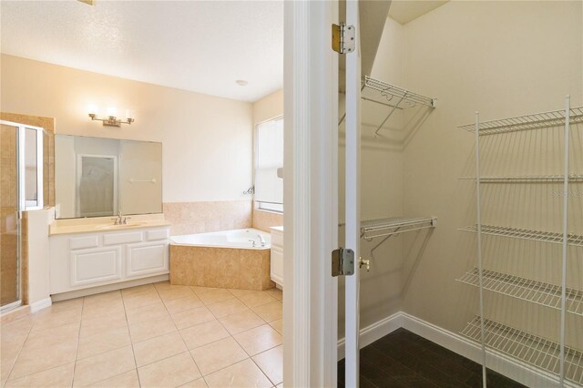 bathroom featuring vanity, tile patterned floors, and separate shower and tub