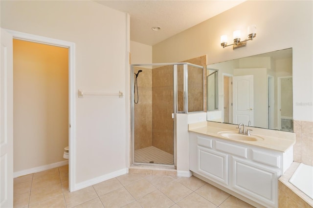 bathroom featuring toilet, vanity, tile patterned floors, and a shower with door